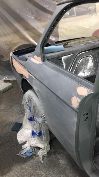 Freshly sanded, straight bodywork ready for painting in the carport paint booth.